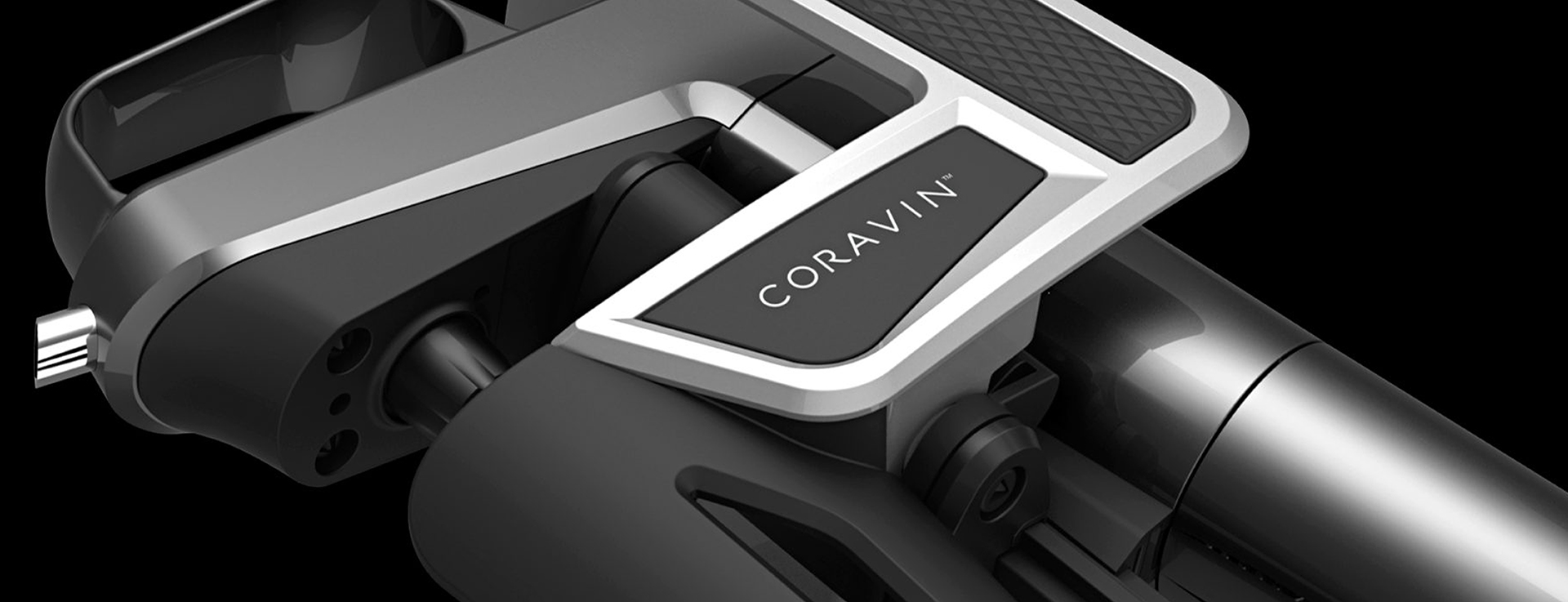 Close-up of the Coravin badge, brushed metal trim, and clamp mechanism on black